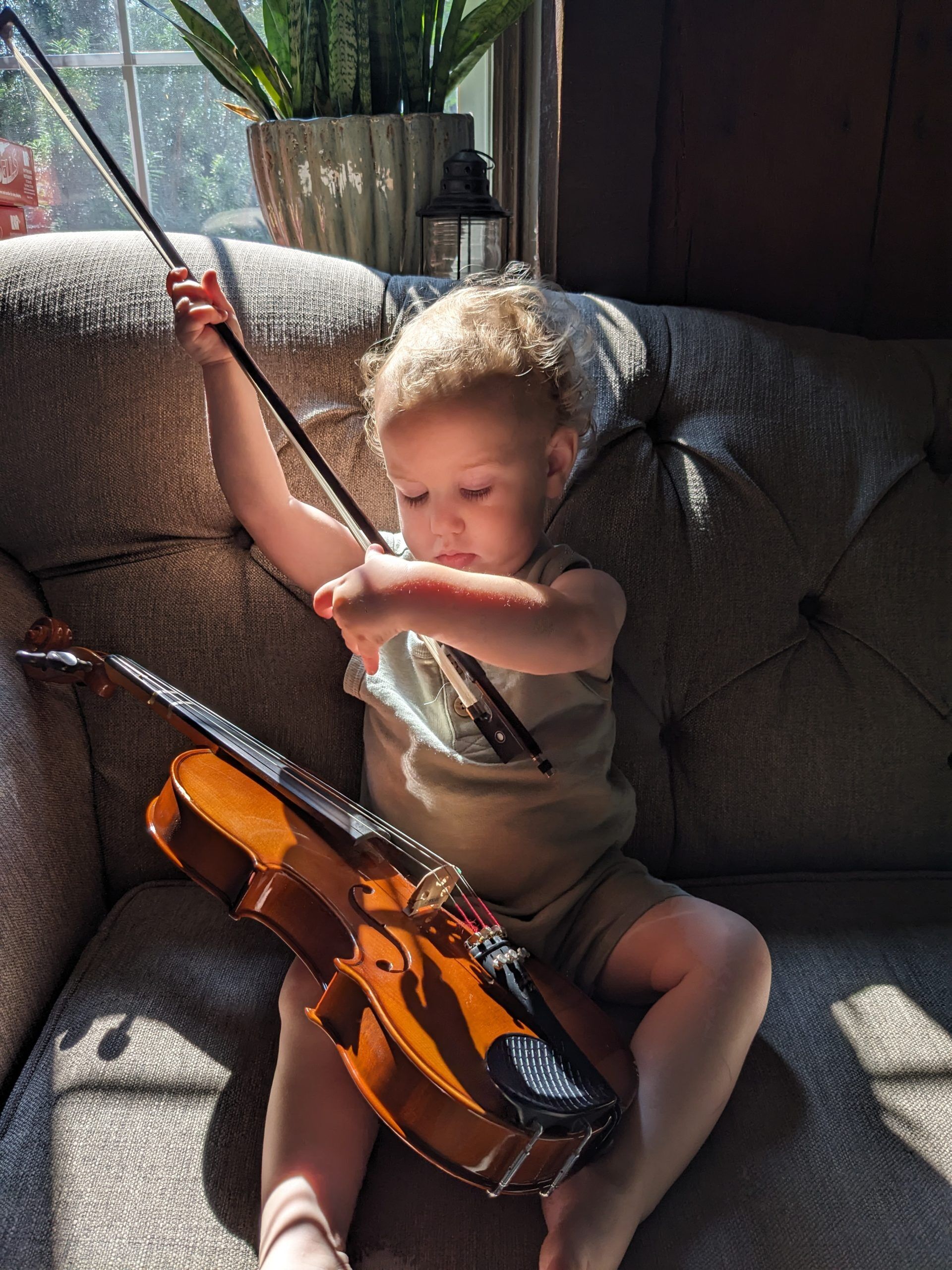 young boy playing a violin